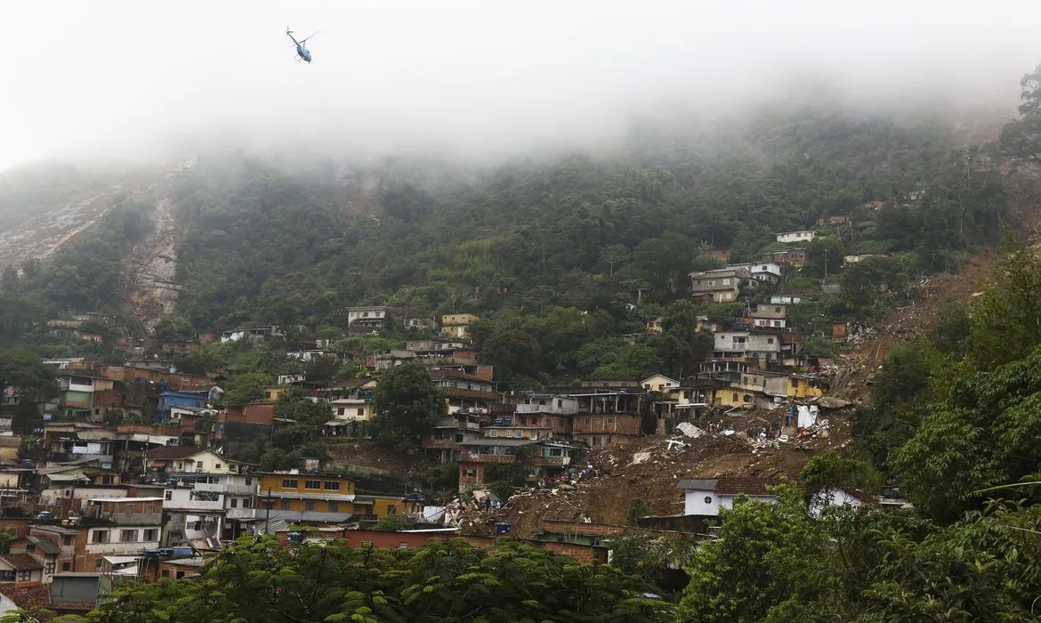 Bombeiros, moradores e voluntários trabalham no local do deslizamento no Morro da Oficina, após a chuva que castigou Petrópolis, na região serrana fluminense