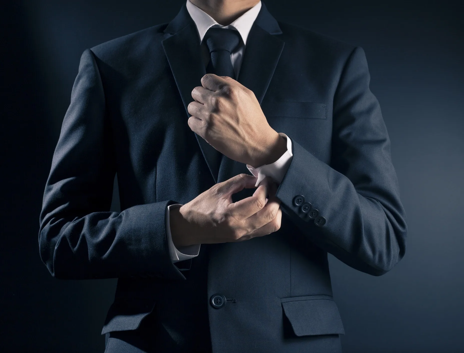 Businessman Fixing Cufflinks his Suit