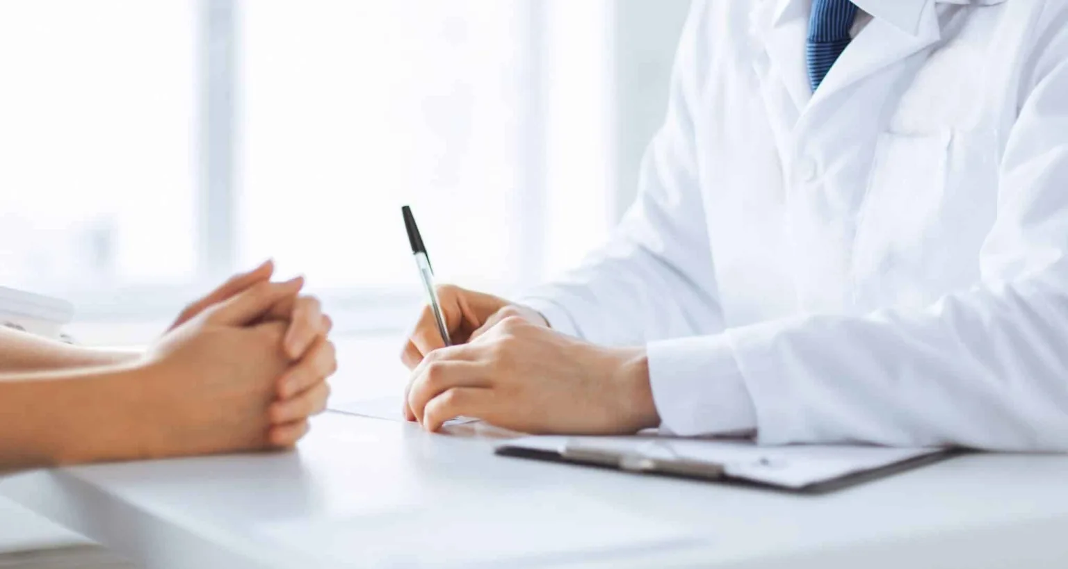 close up of patient and doctor taking notes