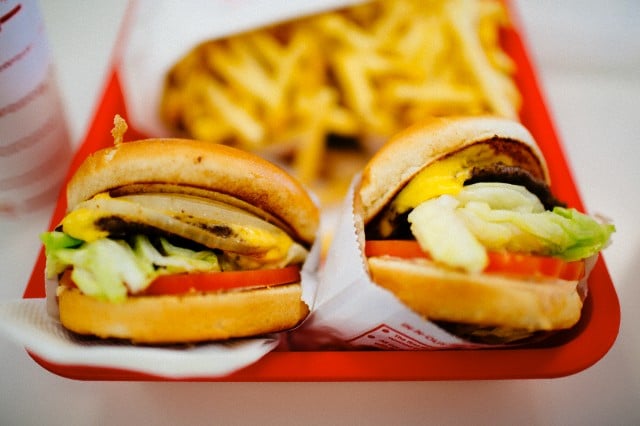 Cheesburgers on plastic tray — Image by © Mother Image/mother image/mother image/Corbis