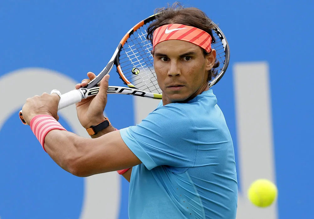 Spain’s Rafael Nadal plays a return shot to Ukraine’s Alexandr Dolgopolov during their men’s singles tennis match at Queen’s tennis championship in London, Tuesday June 16, 2015. (AP Photo/Tim Ireland)