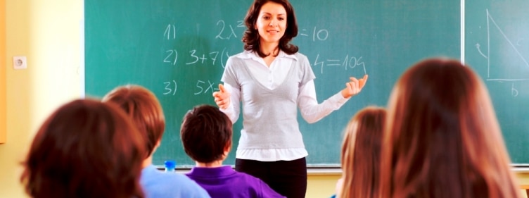 Teacher and student in a classroom at school.