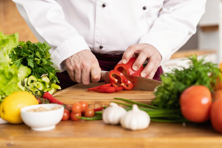 Chef cutting fresh and delicious vegetables for cooking