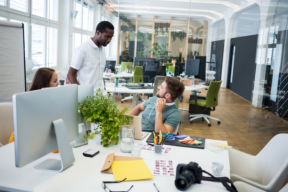 Group of business executives interacting with each other in office