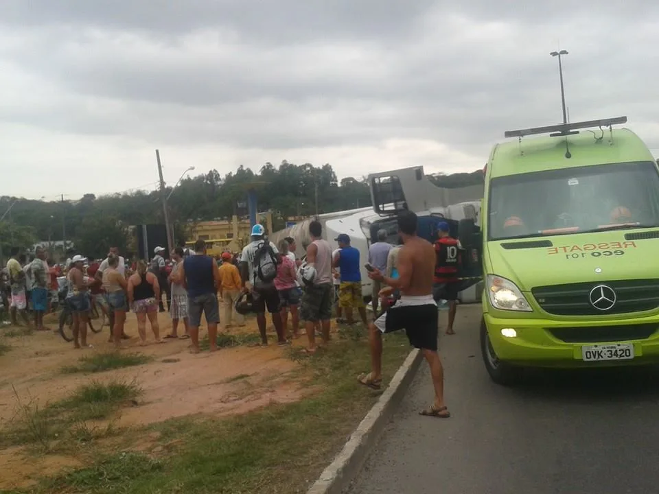 Carreta carregada de eletrodomésticos tomba e populares tentam saquear carga na BR-101, em Guarapari