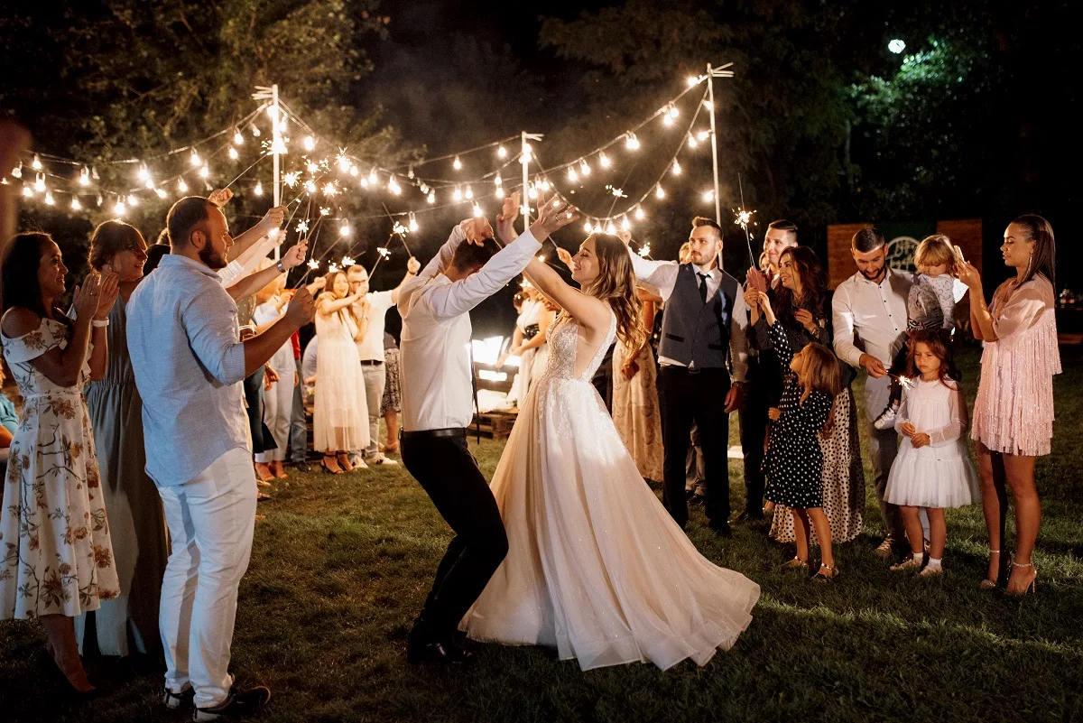 sparklers at the wedding of the newlyweds in the hands of joyful guests