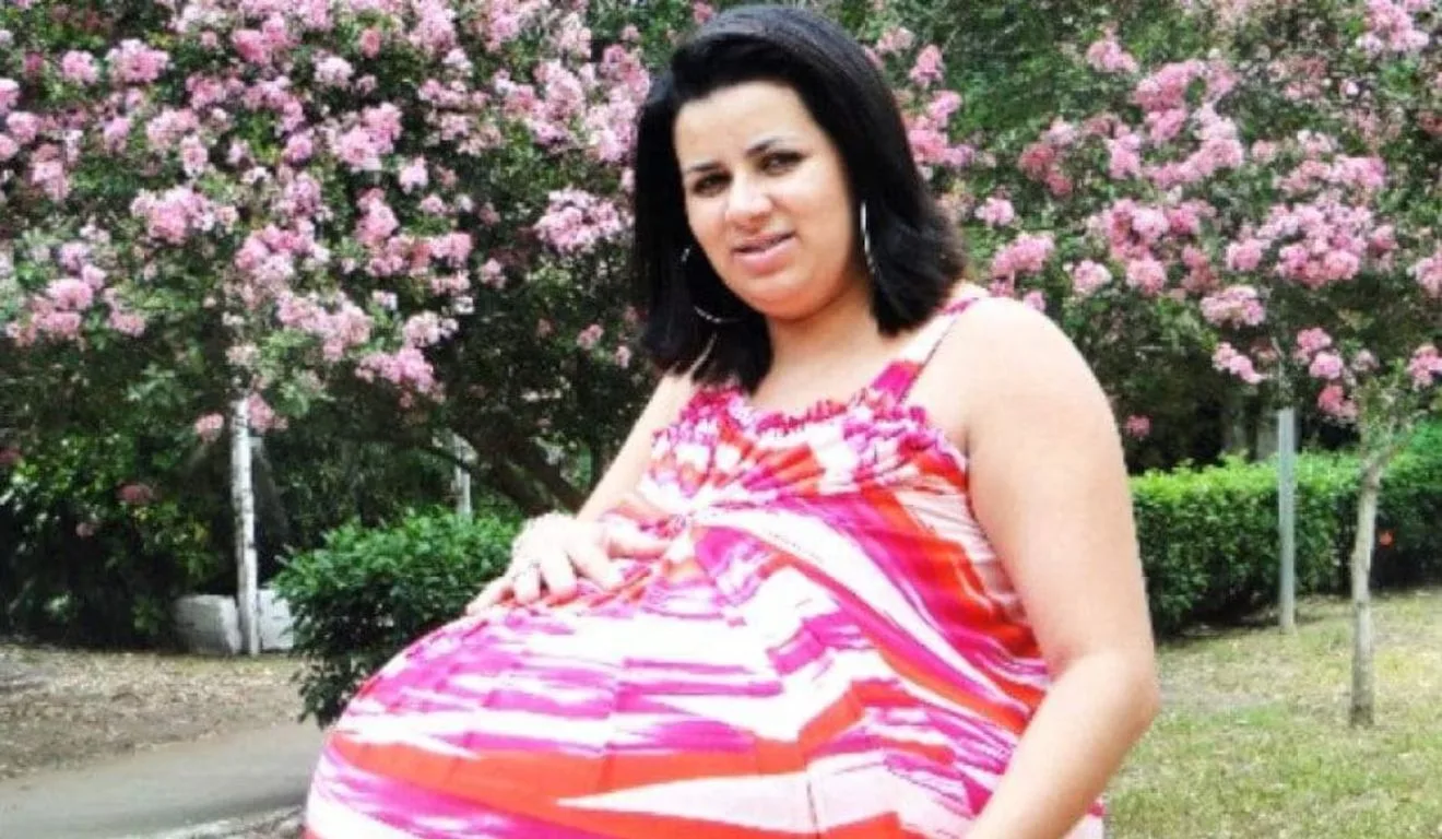 Mulher "gravida" com vestido listrado rosa, branco e laranja. Ela ficou conhecida como "grávida de taubaté"