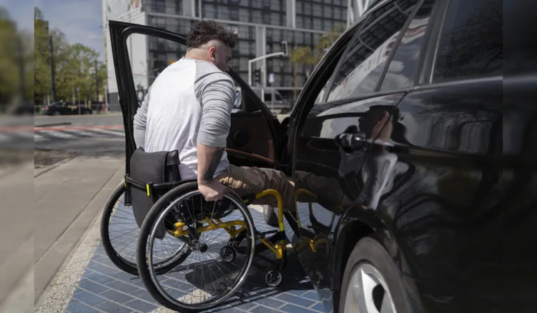 Homem em cadeira de rodas entrando no carro