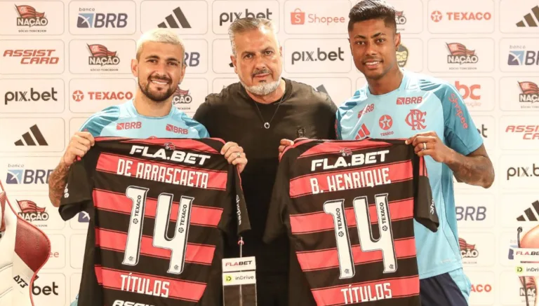 Arrascaeta e Bruno Henrique, com uniforme de treino, recebem a camisa 14 do Flamengo