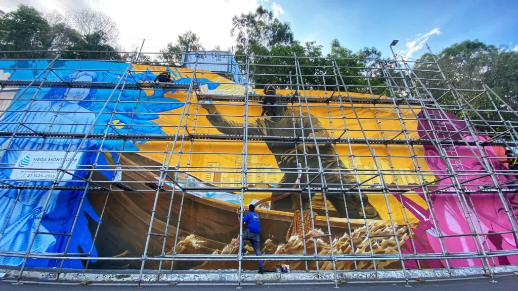 Painel gigante pintado por artistas retrata cultura capixaba na Alça de saída da terceira ponte