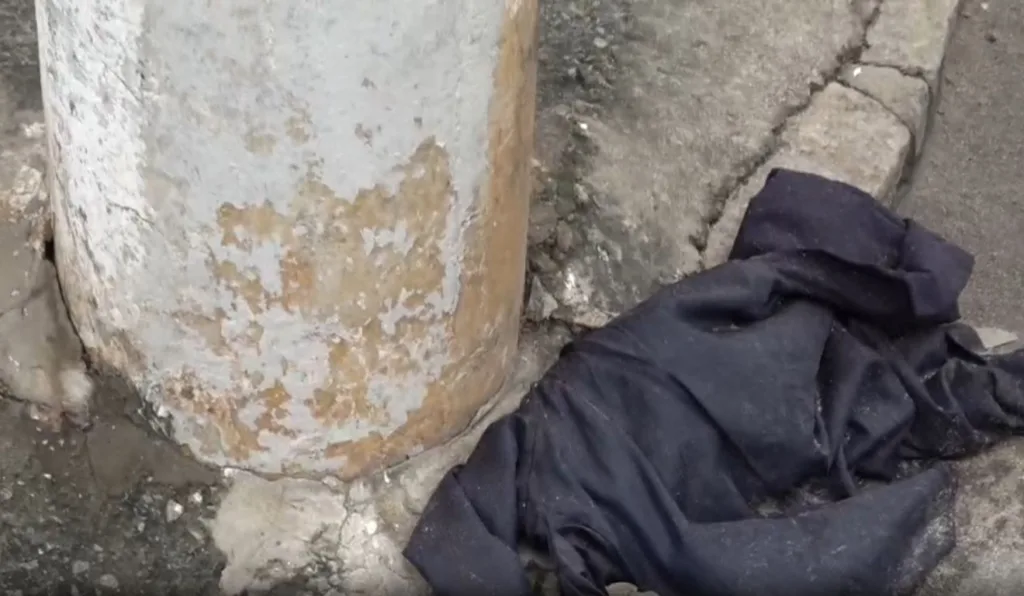 Blusa do homem ficou no chão ao lado de poste em Bela Aurora, Cariacica. Foto: Reprodução/ TV Vitória