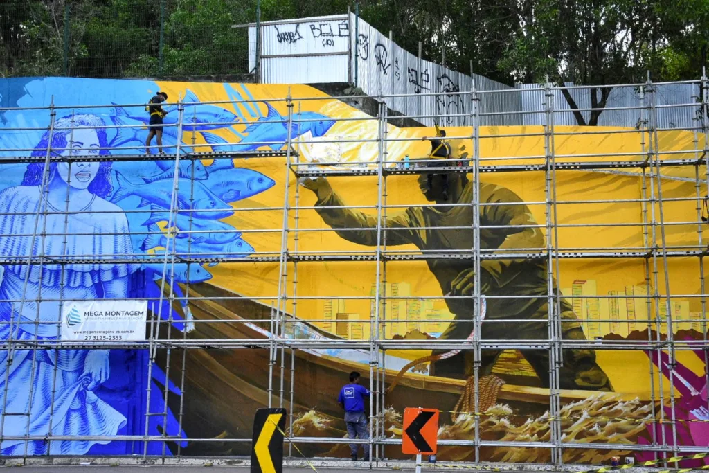 Painel gigante pintado por artistas retrata cultura capixaba na Alça de saída da terceira ponte