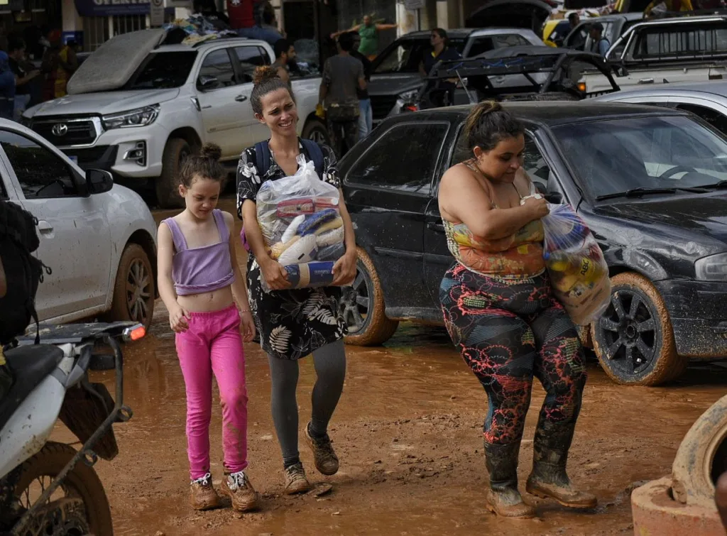 Chuvas no ES, pessoas procuram por roupas e alimentos na lama