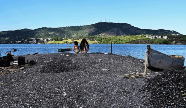 Crianças brincam sobre o monte de cascas de sururu em Porto Novo, Cariacica.