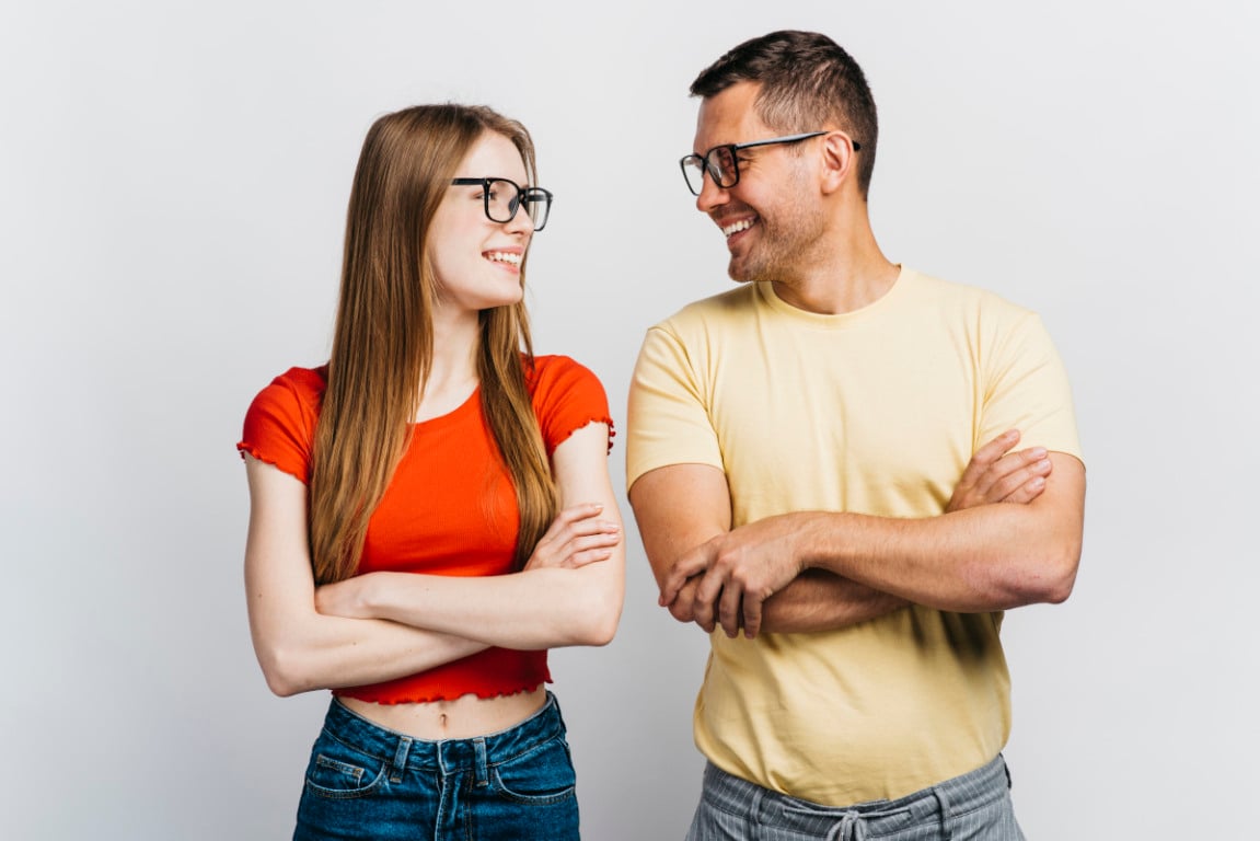 Imagem mostra casal, se olhando de lado, sorrindo, representando cantadas nerd.