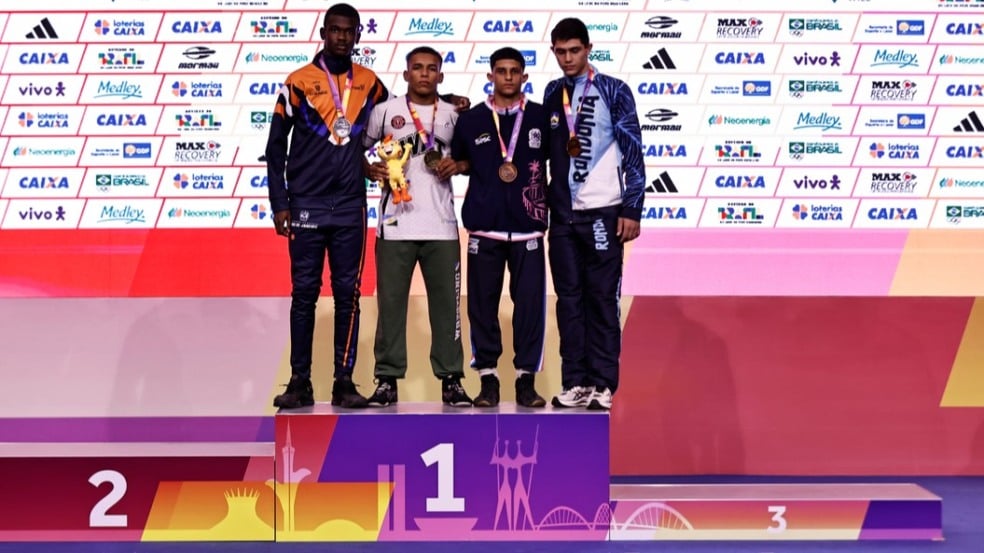 2025.09.15 - Jogos da Juventude CAIXA Brasília 2025 - Wrestling - Cerimônia de premiação da modalidade Wrestling Livre (-71kg) Masculino. A embaixadora atleta Olímpica de Wrestling Giulia Penalber entrega medalhas de bronze para Isaque de Sá Barbatto (ES) e Amir Abdollahzadeh (RO), de prata para Matheus Maxminiano de Souza (RJ) e de ouro para Luis Fernando da Costa Moraes (RR). Foto: Juliana Ávila/COB -IG: @javilaphotos / @timebrasil